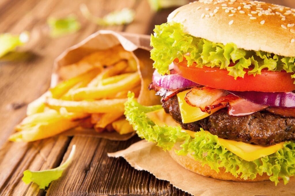 A hamburger and french fries on the table.