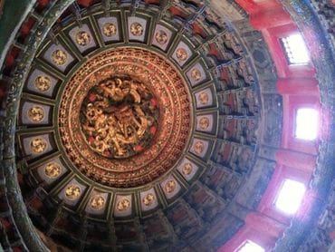 A ceiling with many paintings on it