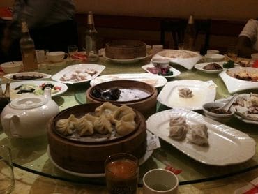 A table filled with plates of food and bowls.