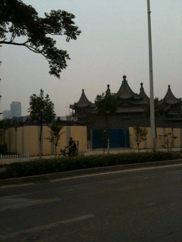 A person riding a bike on the side of road.