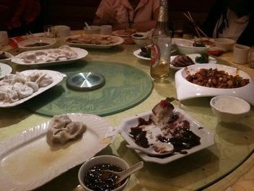 A table with many different plates of food on it