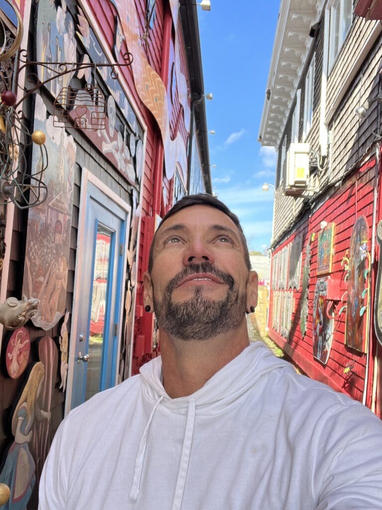 A man standing in the middle of an alley.