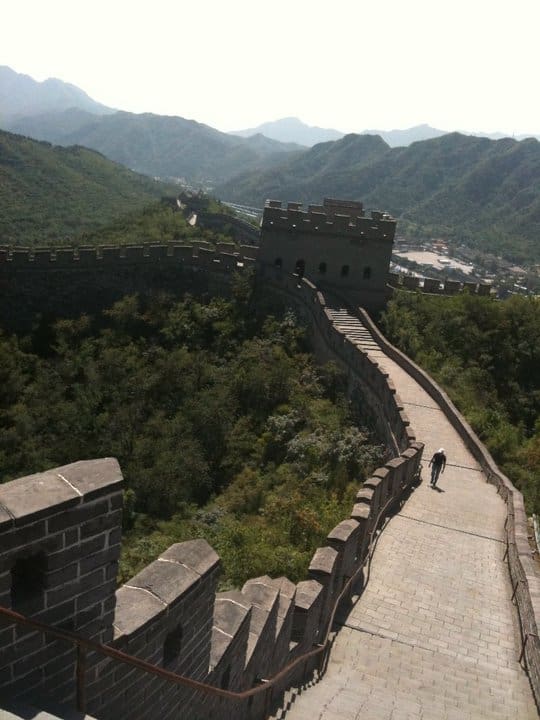 A man walking on the side of a wall.