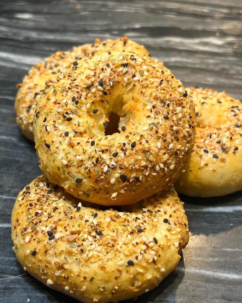 A close up of three bagels on a table