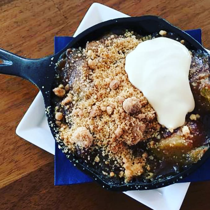 A pan of food with some kind of dessert on top.