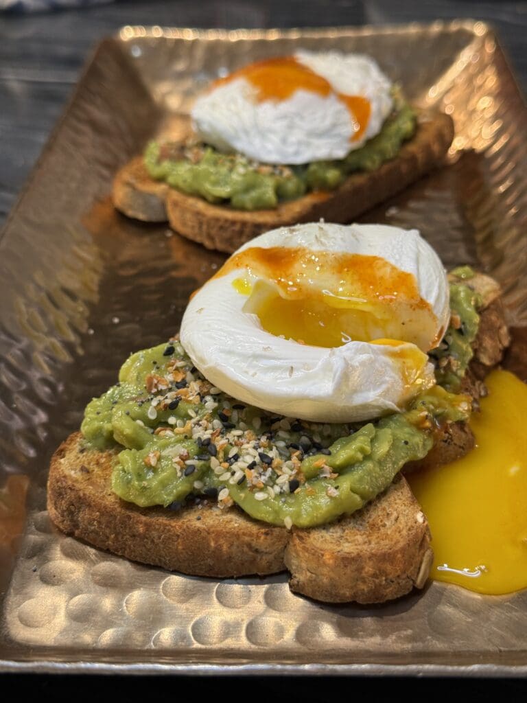 A close up of some toast with an egg on top